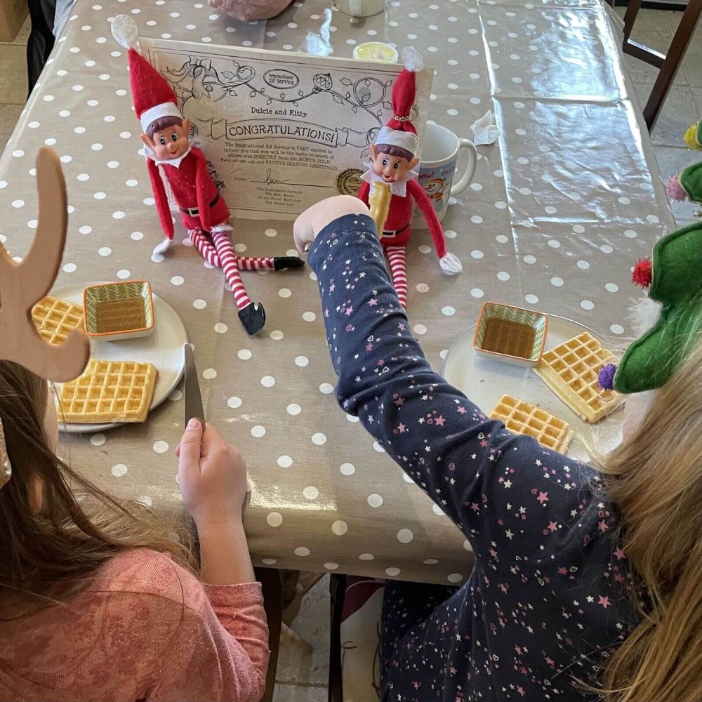 Children enjoying breakfast with Christmas elves and a personalised letter