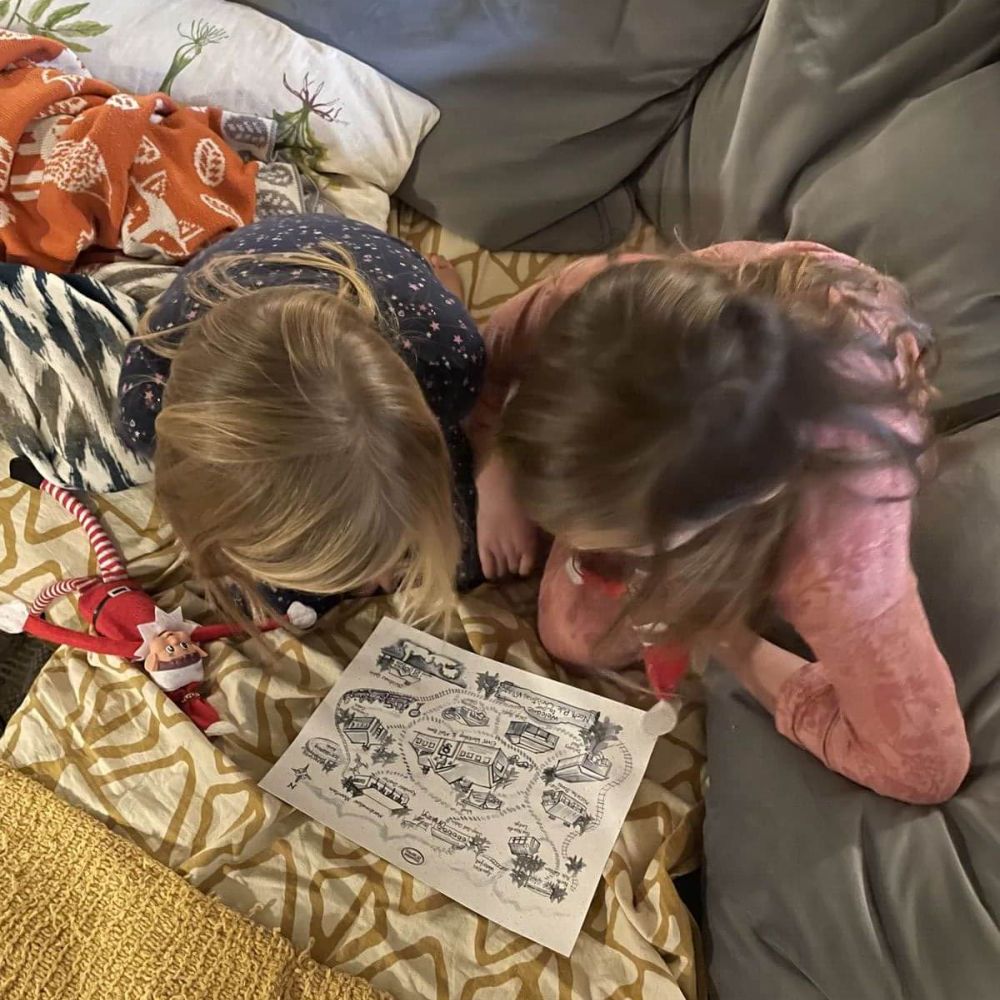 Children discovering International Elf Service Christmas letters with their elves